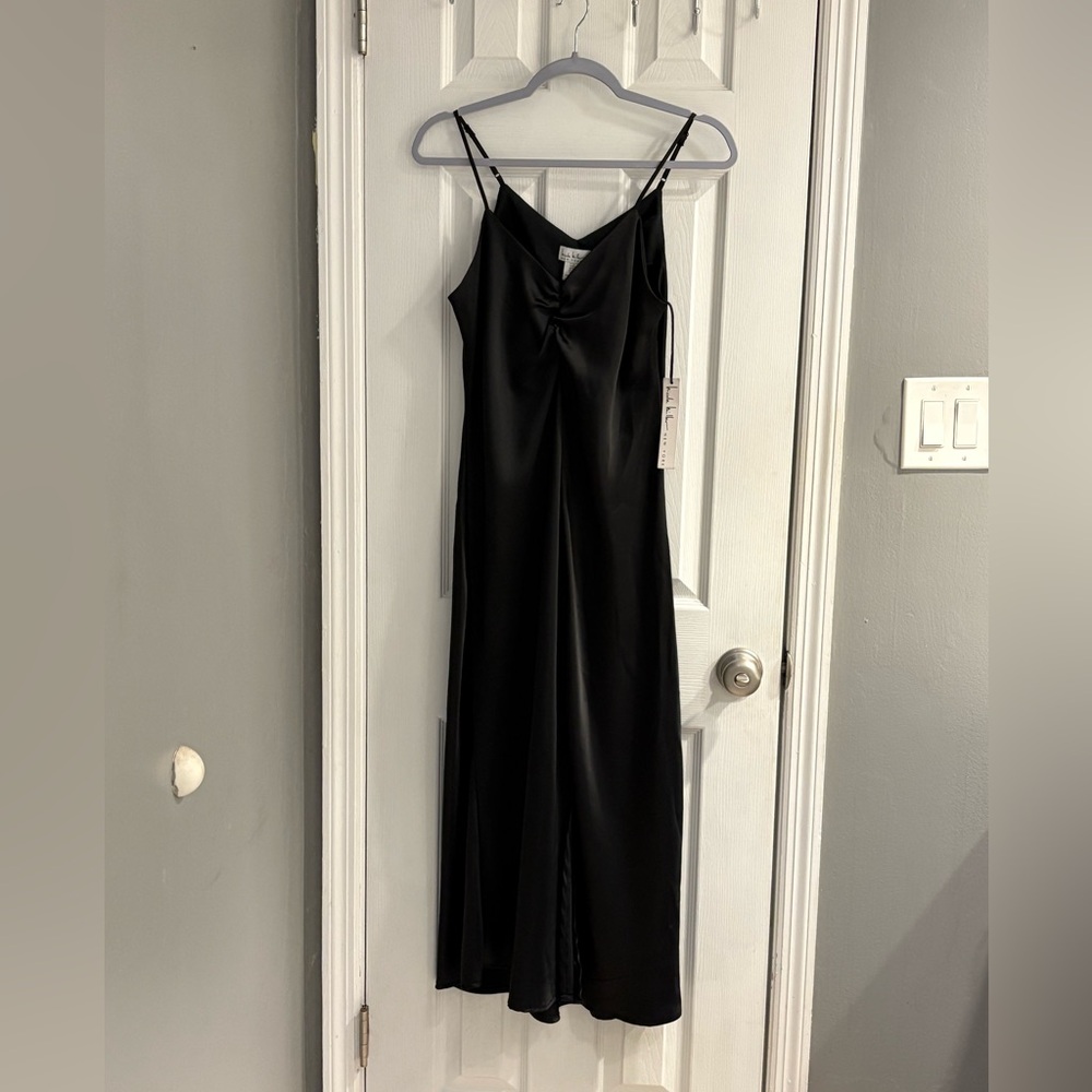 New with tags, Nicole Miller, black long sleeveless gown, size medium.